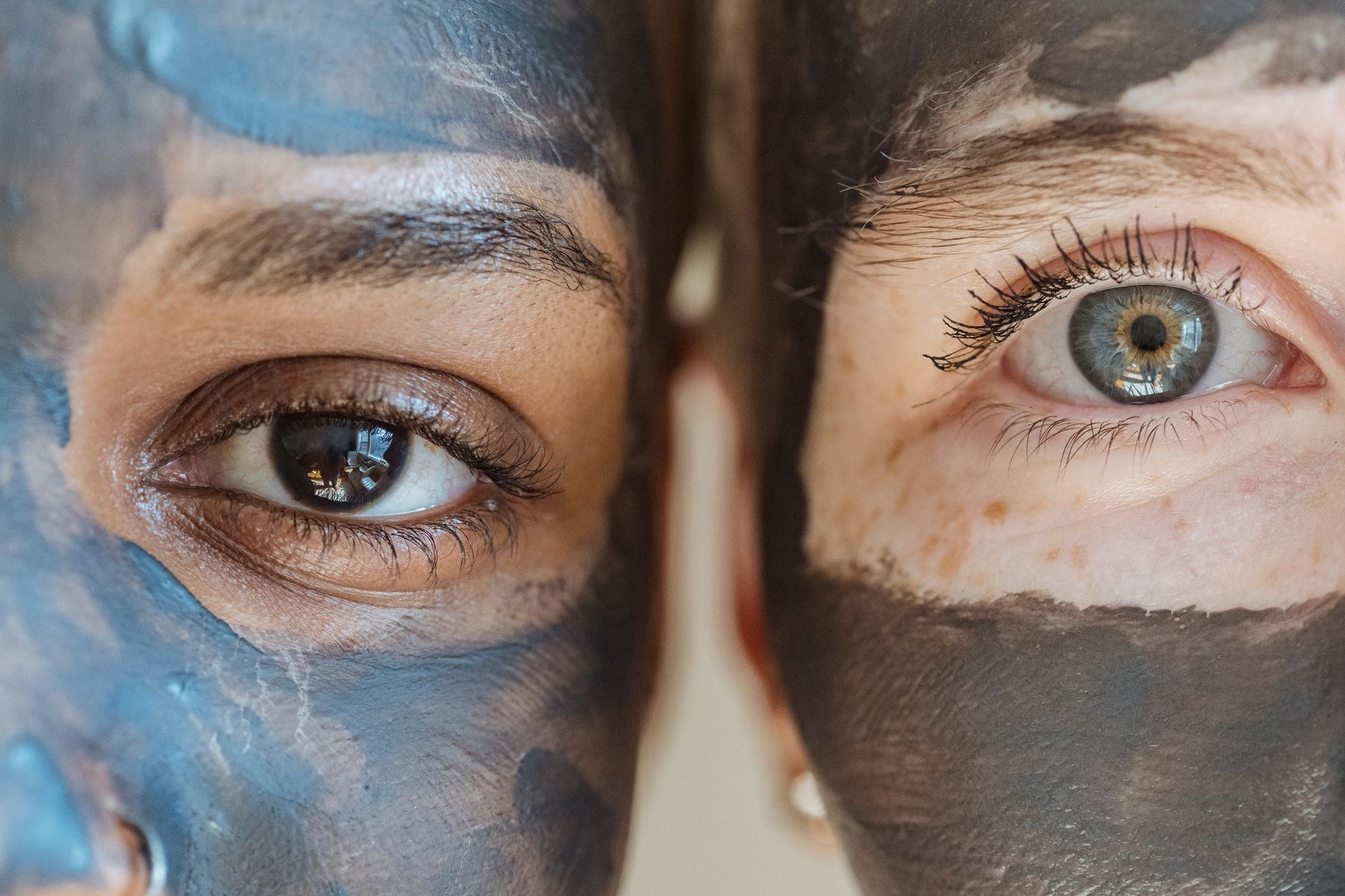 Close-up of a clay facial mask with defined brows and lashes