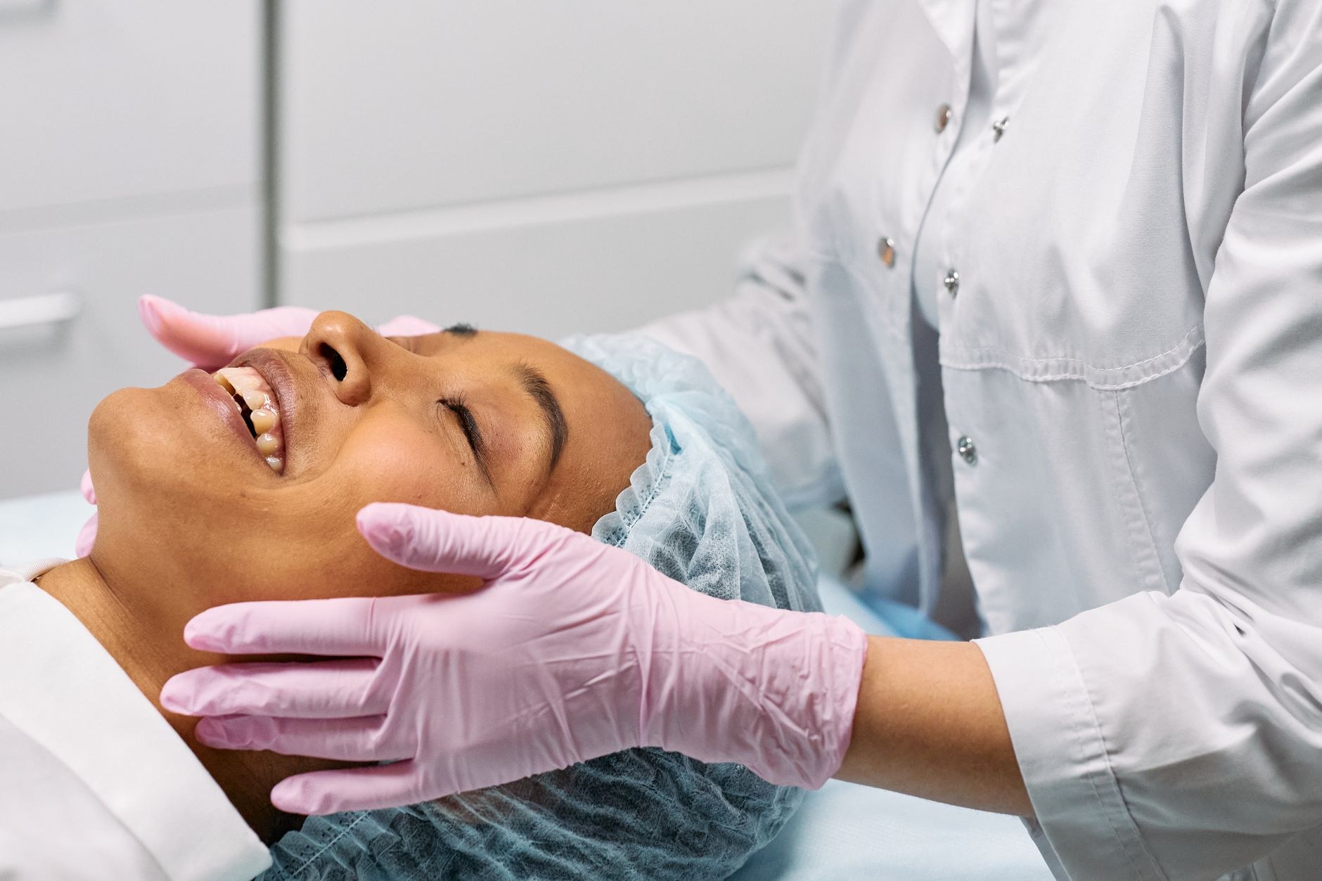 Smiling client enjoying a relaxing facial massage